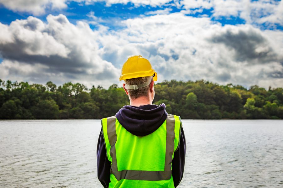 Water engineer surveying a reservoir